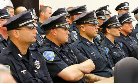 Weymouth police and other officers from surrounding communities fill the courtroom during the arraignment of suspect Emanuel Lopes, 20, in District Courthouse in Quincy, Massachusetts, U.S., July 17, 2018. Pool/Greg Derr/The Patriot Ledger