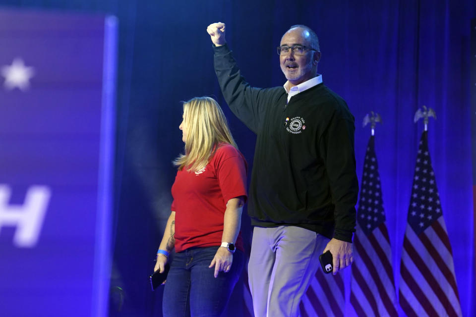 United Auto Workers president Shawn Fain walks onto stage with Dawn Simms, UAW Local 126 member, before President Joe Biden speaks to UAW members at the Community Building Complex of Boone County, Thursday, Nov. 9, 2023, in Belvidere, Ill. (AP Photo/Evan Vucci)