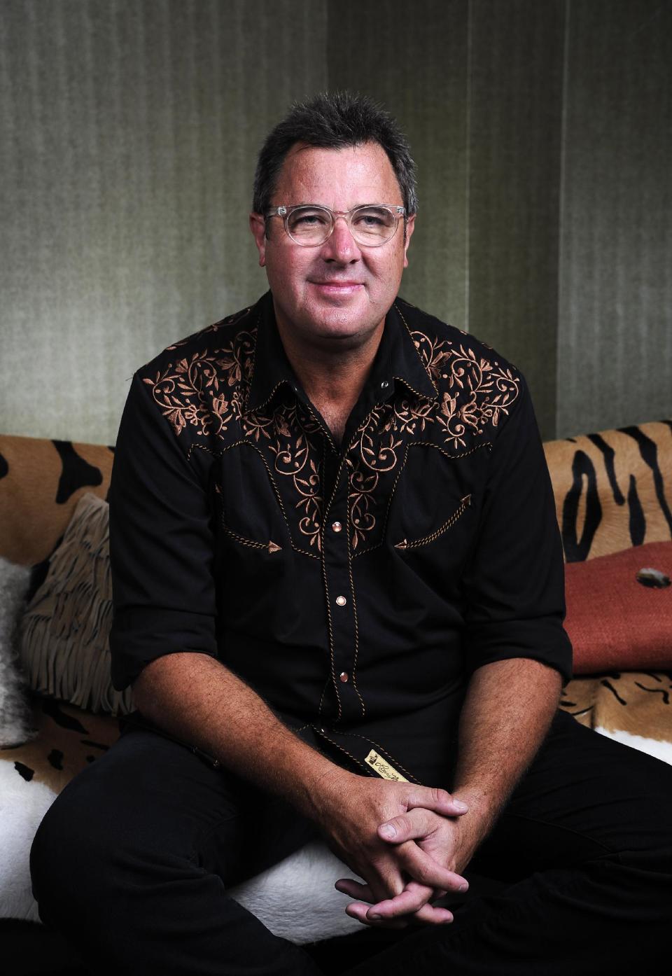This Saturday, July 27, 2013 photo shows Vince Gill posing at the Grand Ole Opry in Nashville, Tenn. Gill and Franklin released their latest album "Bakersfield," on July 30. (Photo by Donn Jones/Invision/AP)
