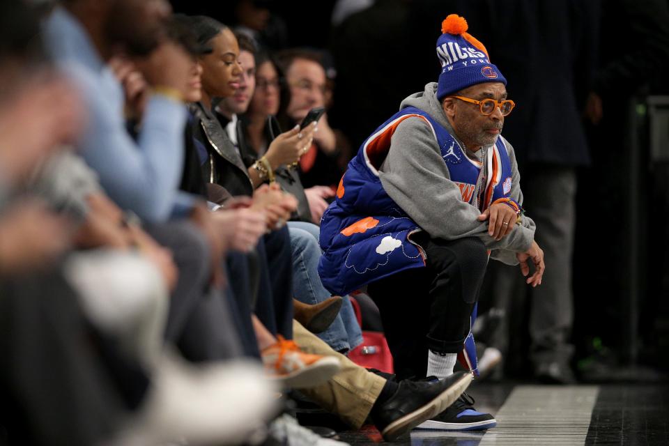 Jan 23, 2024; Brooklyn, New York, USA; American director and Knicks fan Spike Lee kneels court side during the fourth quarter between the Brooklyn Nets and the New York Knicks at Barclays Center. Mandatory Credit: Brad Penner-USA TODAY Sports