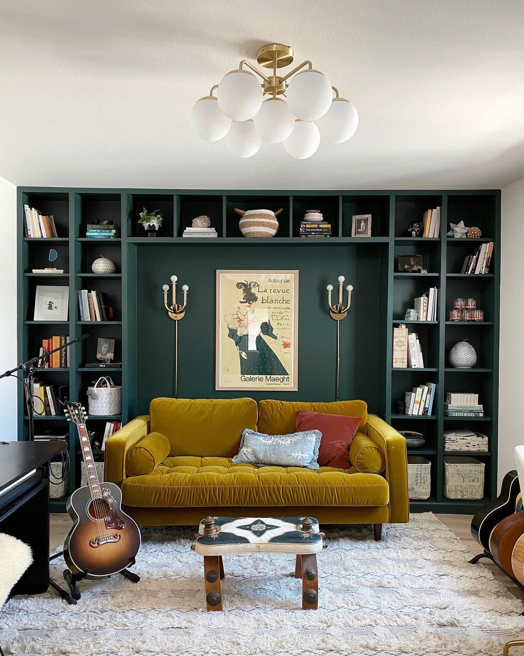 a room with a couch and a shelf with books
