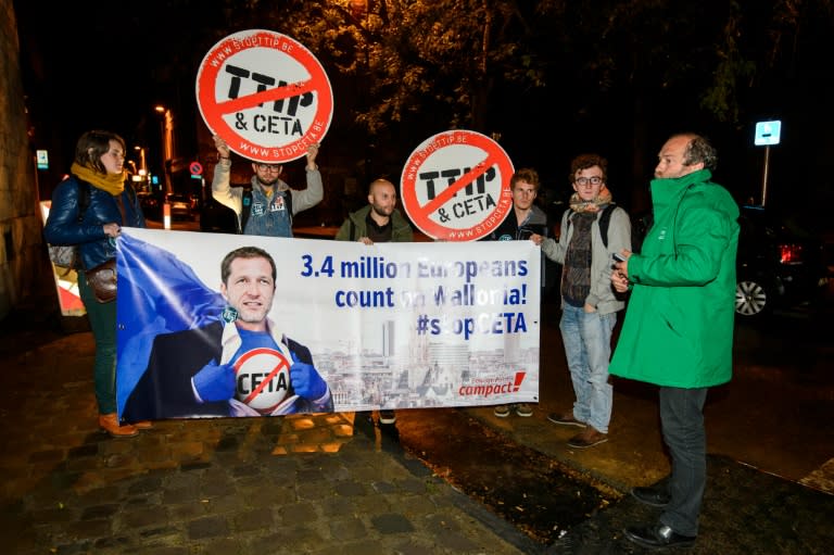 Protesters hold up a #stopCETA placard outside a meeting on CETA (EU-Canada Comprehensive Economic and Trade Agreement) in the Walloon parliament in Namur, Belgium, on October 18, 2016