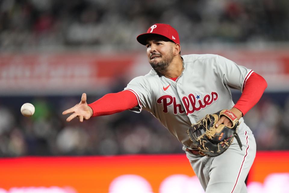 Philadelphia Phillies first baseman Darick Hall tosses the ball to starting pitcher Taijuan Walker during the fourth inning of a baseball game against the New York Yankees, Monday, April 3, 2023, in New York. New York Yankees' Jose Trevino was out at first base on the play. (AP Photo/Frank Franklin II)