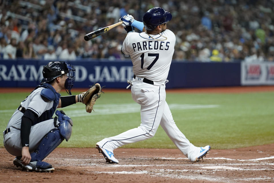 Tampa Bay Rays' Isaac Paredes (17) watches his two-run home run off New York Yankees' Clarke Schmidt during the fifth inning of a baseball game Tuesday, June 21, 2022, in St. Petersburg, Fla. Catching for New York is Kyle Higashioka. (AP Photo/Chris O'Meara)