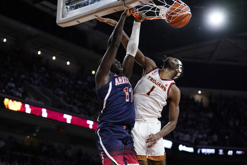 Arizona center Oumar Ballo (11) dunks over Southern California forward Chevez Goodwin (1) during the first half of an NCAA college basketball game Tuesday, March 1, 2022, in Los Angeles. (AP Photo/Marcio Jose Sanchez)