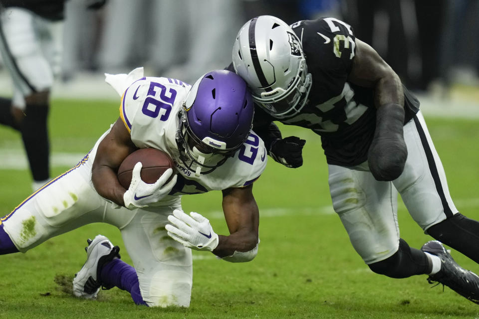 Las Vegas Raiders safety Tyree Gillespie collides with Minnesota Vikings running back Kene Nwangwu during the first half of an NFL preseason football game, Sunday, Aug. 14, 2022, in Las Vegas. (AP Photo/John Locher)