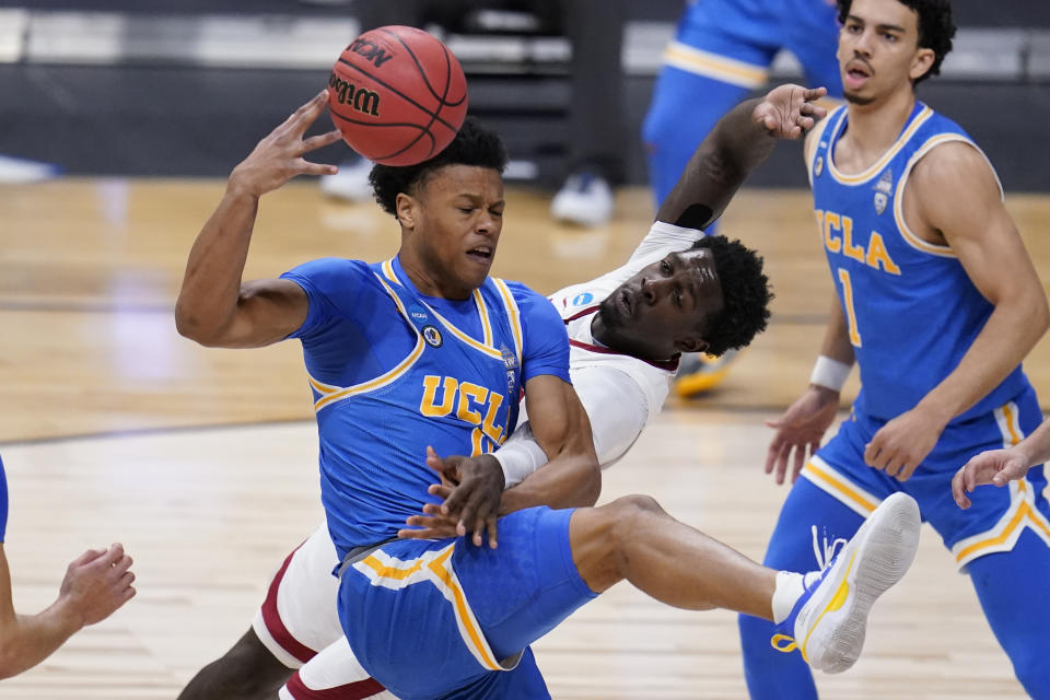 UCLA guard Jaylen Clark (0) and Alabama forward Juwan Gary (4) collide in the first half of a Sweet 16 game in the NCAA men's college basketball tournament at Hinkle Fieldhouse in Indianapolis, Sunday, March 28, 2021. (AP Photo/Michael Conroy)