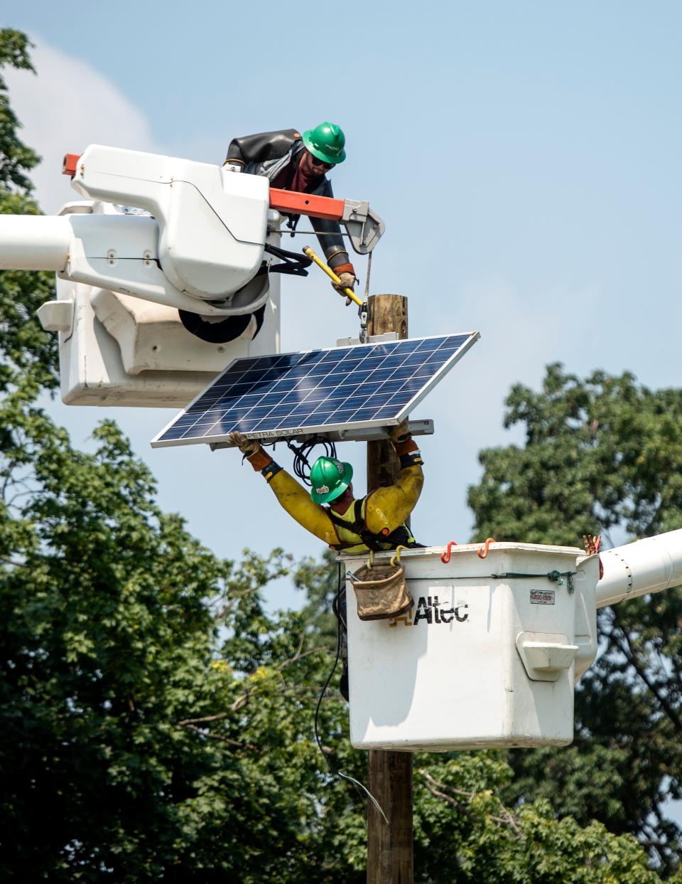 PSE&G subcontractors replace utility poles, solar panels and repair downed wires on Day St., along the Clifton High School stadium, on Wednesday, July 7, 2021 from thunderstorms the prior evening.