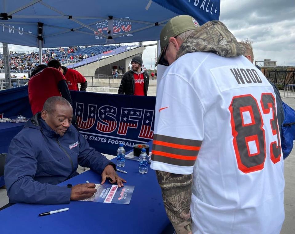 Frank Minnifield, a former Cleveland Browns standout, signs an autograph on Sunday at the USFL game between New Jersey and Pittsburgh at Tom Benson Hall of Fame Stadium in Canton. Minnifield also played in the original USFL in the 1980s.