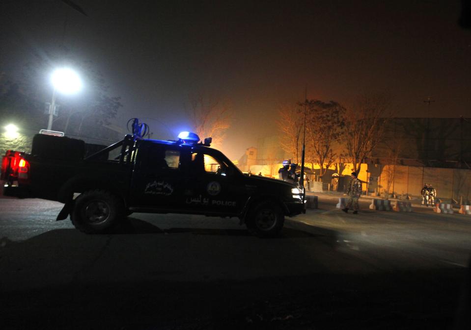 Afghan security personnel keep watch near the site of an explosion in Kabul