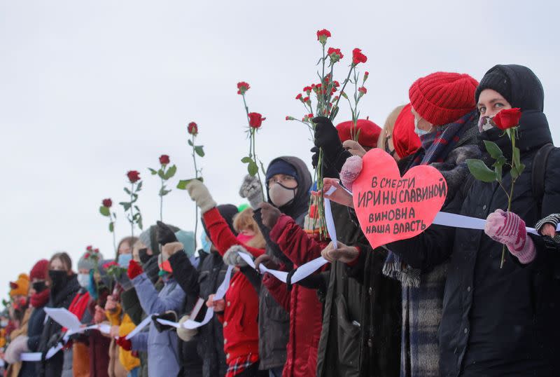 Participants form a human chain during a demonstration to support female political prisoners and to protest against police violence in Saint Petersburg