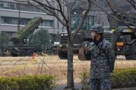 A Japanese soldier stands guard near a PAC-3 missile launcher -- which is used to engage incoming ballistic missile threats -- outside the Defence Ministry in Tokyo, on March 6, 2017