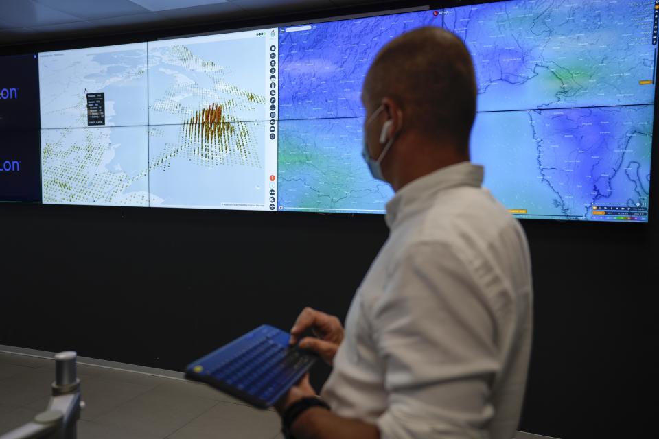 A police officer monitors screens showing the flow of people and web cameras at a police station, in Venice, Italy, Thursday, June 17, 2021. After a 15-month pause in mass international travel, Venetians are contemplating how to welcome visitors back to the picture-postcard canals and Byzantine backdrops without suffering the indignities of crowds clogging its narrow alleyways, day-trippers perched on stoops to imbibe a panino and hordes of selfie-takers straining for a spot on the Rialto Bridge or in front of St. Mark’s Basilica. (AP Photo/Luca Bruno)