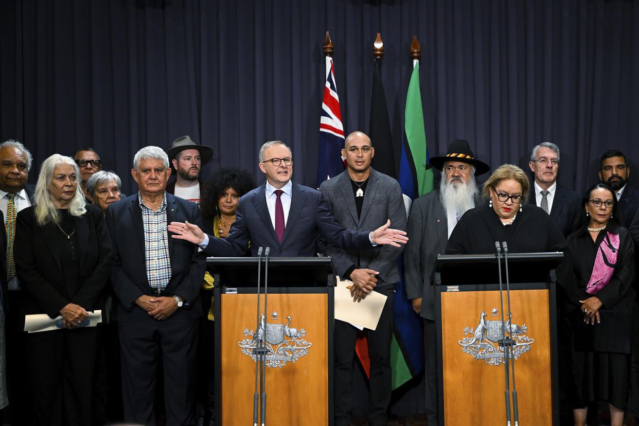 Australian Prime Minister Anthony Albanese, at the left podium, is surrounded by members of the First Nations Referendum Working Group during a press conference at Parliament House in Canberra, Australia, on March 23, 2023.