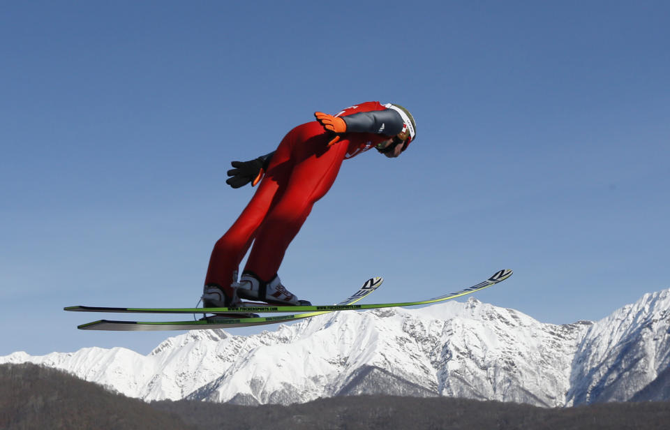 Poland's Kamil Stoch makes an attempt during the men's normal hill ski jumping training at the 2014 Winter Olympics, Friday, Feb. 7, 2014, in Krasnaya Polyana, Russia. (AP Photo/Matthias Schrader)