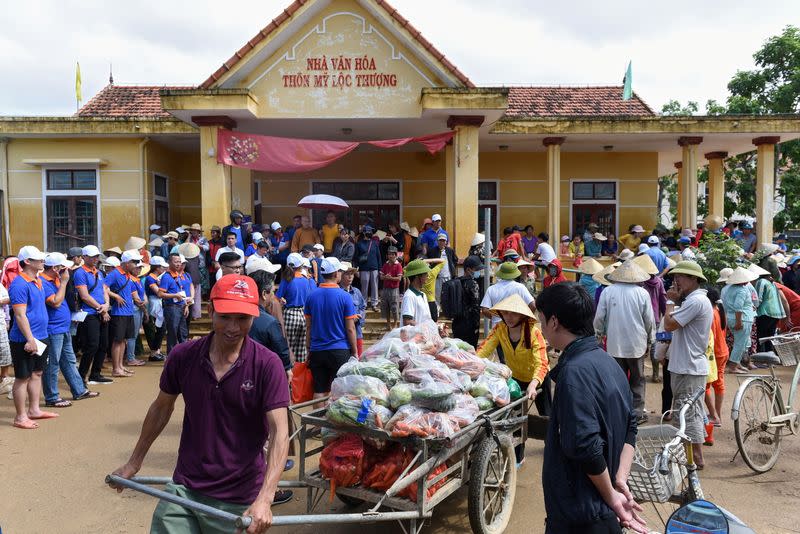 A couple transport foods relief to provide for flood affected residents at My Thuong Loc village in Quang Binh province