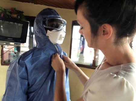Reuters video cameraman Djaffar Al Katanty dresses in an Ebola protective suit during training in Butembo
