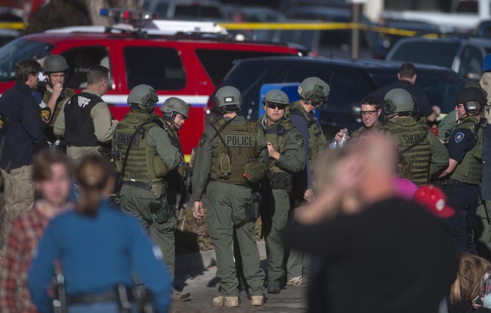 Arapahoe police gather at parking lots across from Arapahoe High School, after a student opened fire in the school in Centennial, Colorado December 13, 2013. The student seeking to confront one of his teachers opened fire at the Colorado high school on Friday, wounding at least two classmates before apparently taking his own life, law enforcement officials said. REUTERS/Evan Semon (UNITED STATES - Tags: EDUCATION CRIME LAW)