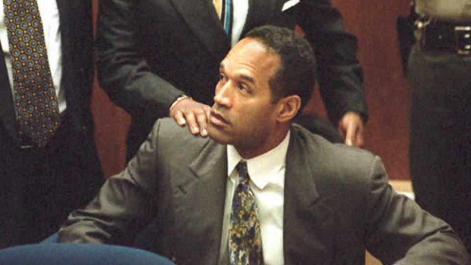 PHOTO: OJ Simpson is seen with his legal team during the opening of the double homicide trial on January 5, 1995. (AFP/Getty Images)