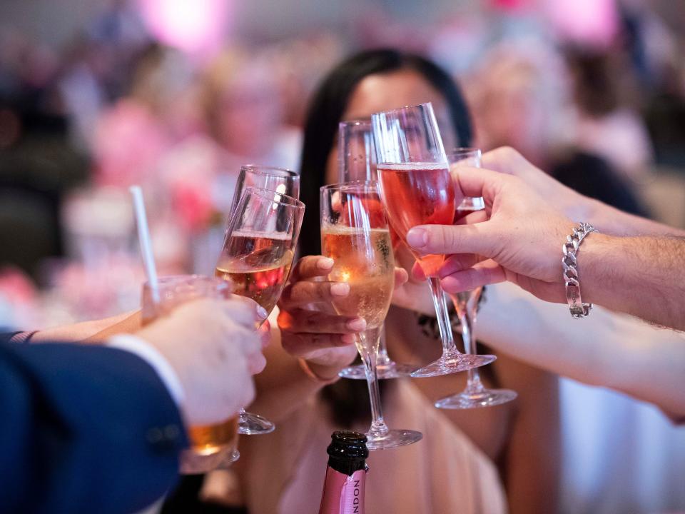 Guests raise their glasses for a Champagne toast
