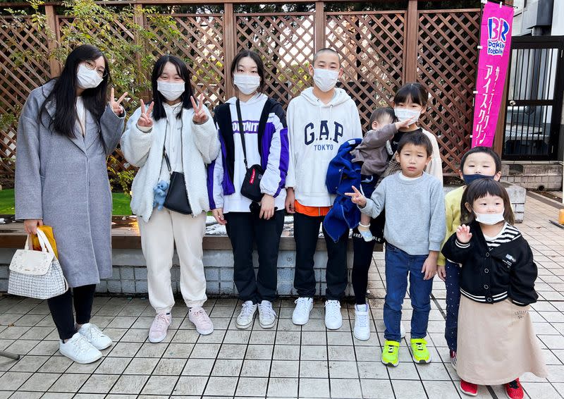 Children of Keiki Nambu and his wife Takako pose for a photograph during their family shopping in Tokyo