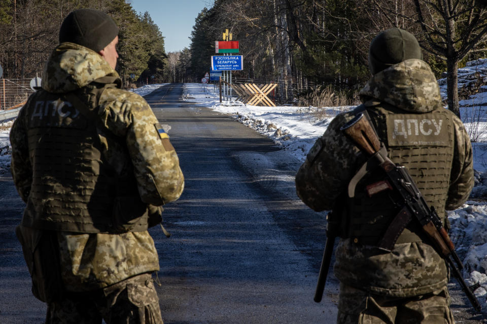 VILCHA, UKRAINE - FEBRUARY 13: Members of the Ukrainian State Border Guard stand watch at the border crossing between Ukraine and Belarus on February 13, 2022 in Vilcha, Ukraine. Russian forces are conducting large-scale military exercises in Belarus, across Ukraine's northern border, amid a tense diplomatic standoff between Russia and Ukraine's Western allies. Ukraine has warned that it is virtually encircled, with Russian troops massed on its northern, eastern and southern borders. The United States and other NATO countries have issued urgent alerts about a potential Russian invasion, hoping to deter Vladimir Putin by exposing his plans, while trying to negotiate a diplomatic solution. (Photo by Chris McGrath/Getty Images)