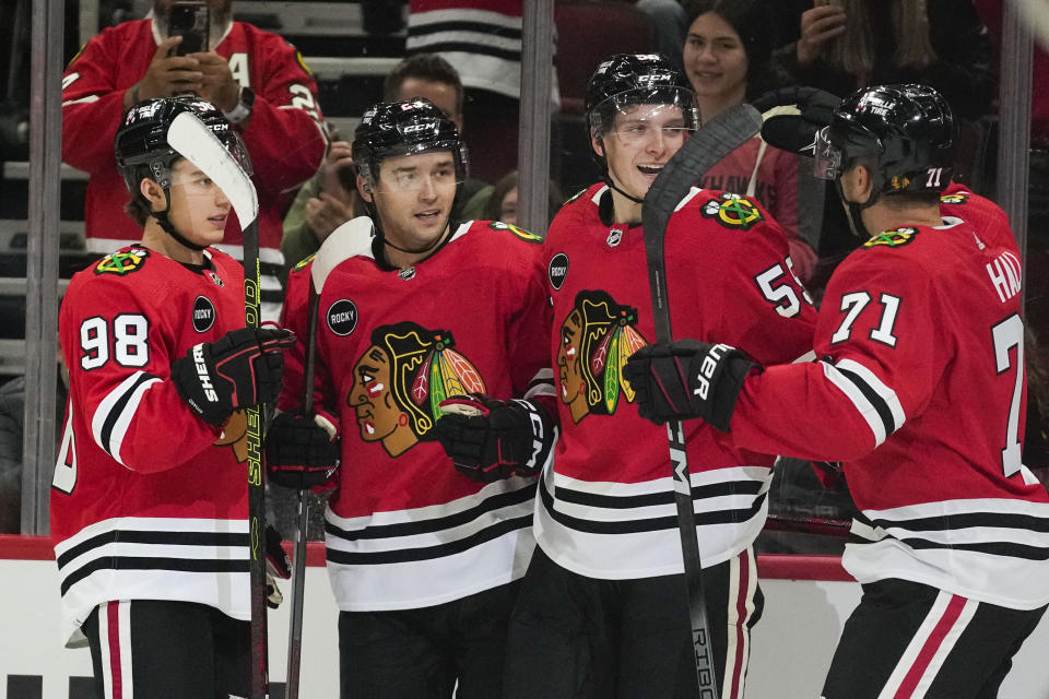 Chicago Blackhawks' Connor Bedard, Philipp Kurashev, Kevin Korchinski and Taylor Hall, from left, celebrate Kurashev's goal against the St. Louis Blues during the second period of a preseason NHL hockey game Thursday, Sept. 28, 2023, in Chicago. (AP Photo/Erin Hooley)