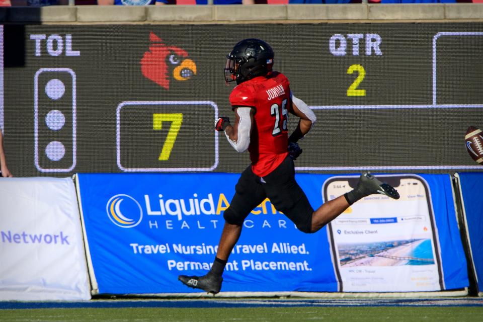 Dec 28, 2021; Dallas, Texas, USA; Louisville Cardinals running back Jawhar Jordan (25) scores a touchdown on a kickoff during the first half against the Air Force Falcons during the 2021 First Responder Bowl at Gerald J. Ford Stadium. Mandatory Credit: Jerome Miron-USA TODAY Sports