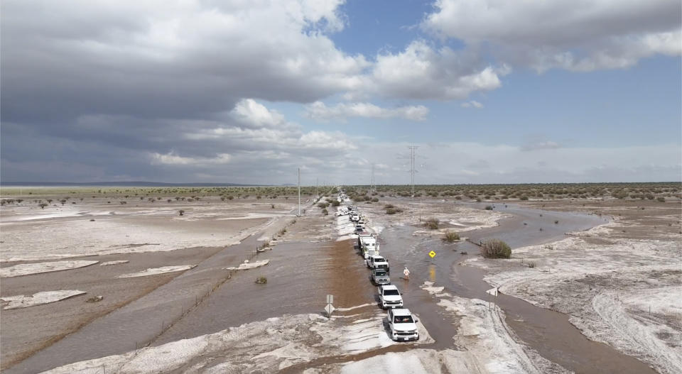 In this photo provided by Mike Bischoff, Vehicles are lined up after flash flooding along Highway 42 near Willard, N.M., on Wednesday, June 19, 2024. (Mike Bischoff @blueskyproductionsutah via AP)