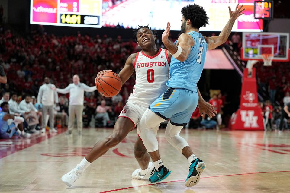 Houston guard Marcus Sasser (0) is defended by Kent State guard Sincere Carry (3) during the second half Saturday, Nov. 26, 2022, in Houston.