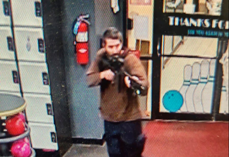 In this image taken from video released by the Androscoggin County Sheriff’s Office, an unidentified gunman points a gun while entering Sparetime Recreation in Lewiston, Maine, on Wednesday, Oct. 25, 2023. Maine State Police ordered residents in the state’s second-largest city to shelter in place Wednesday night as the suspect remains at large. (Androscoggin County Sheriff’s Office via AP)