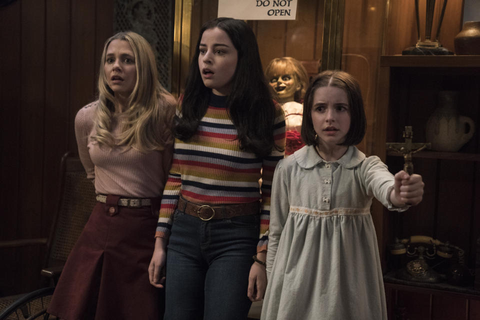 This image released by Warner Bros. Pictures shows Madison Iseman, from left, Katie Sarife and McKenna Grace in a scene from the horror film, "Annabelle Comes Home." (Dan McFadden/Warner Bros. Pictures via AP)