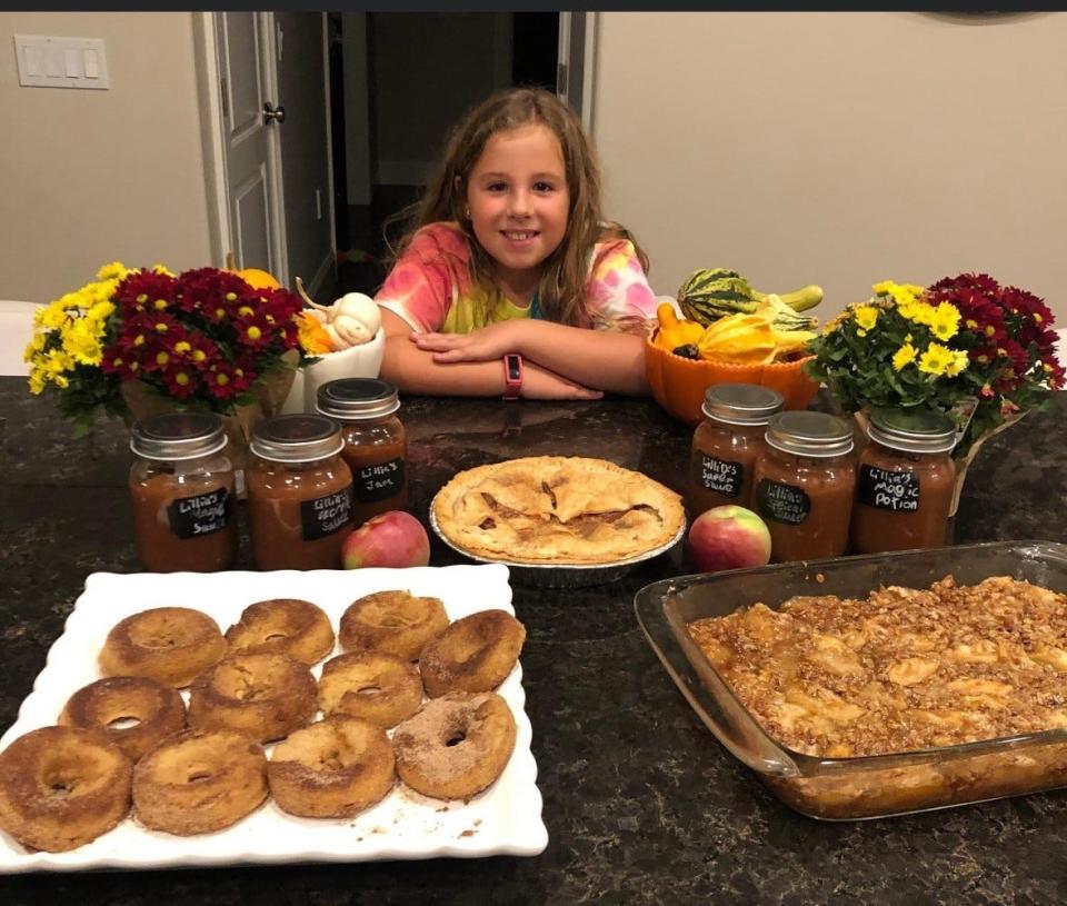 Lillia James, 9, is behind Them Apples, selling home-made apple sauce, apple butter, and apple pies from the orchard of her father's backyard in Hampton Falls.