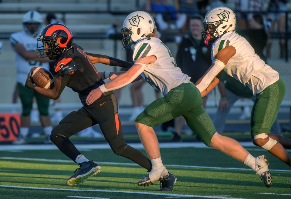 Manual’s Amane Breedlove (2) tries to escape the Richwoods defense in the first half of their Week 2 football game Friday, Sept. 6, 2024 at Peoria Stadium. The Knights defeated the Rams 15-6.