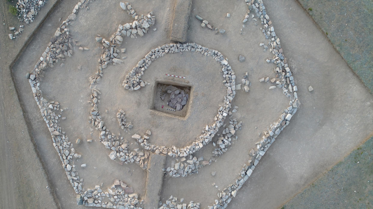  An aerial view of the hexagonal-shaped pyramid in Kazakhstan. Notice how the inner stone walls form a maze-like path that leads toward the burial site at its center. 