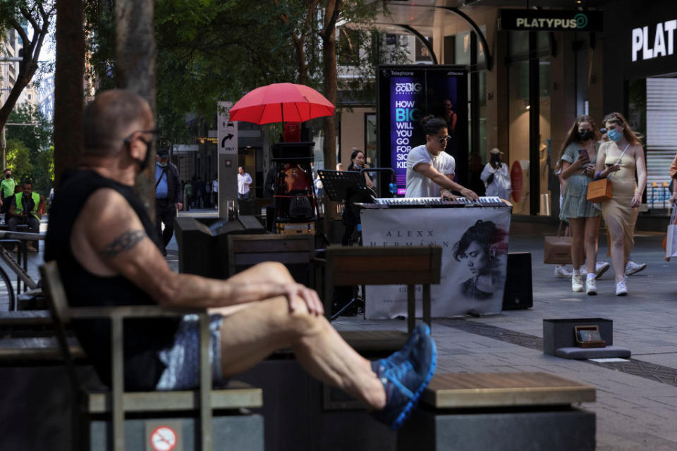 Pedestrians and a street performer are seen in Pitt Street Mall.