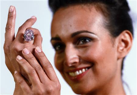 A model displays the 'Pink Star' 59.60 carat oval cut pink diamond at Sotheby's in Geneva September 25, 2013. REUTERS/Ruben Sprich