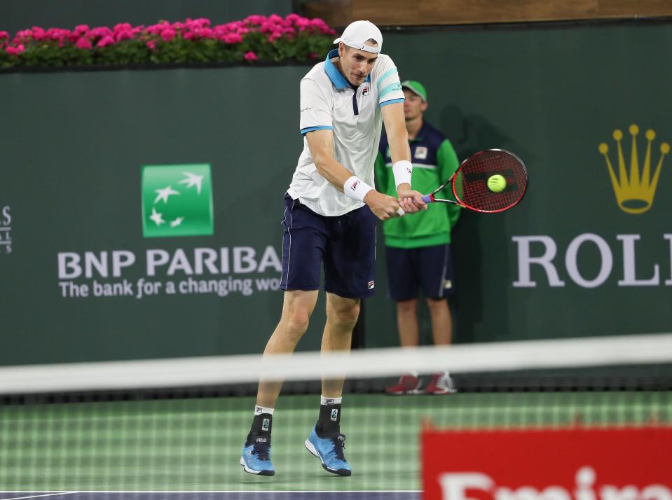 John Isner hits a shot during his doubles match with Jack Sock against Simone Bilelli and Fabio Fognini during the BNP Paribas Open in Indian Wells, Calif., March 15, 2023.