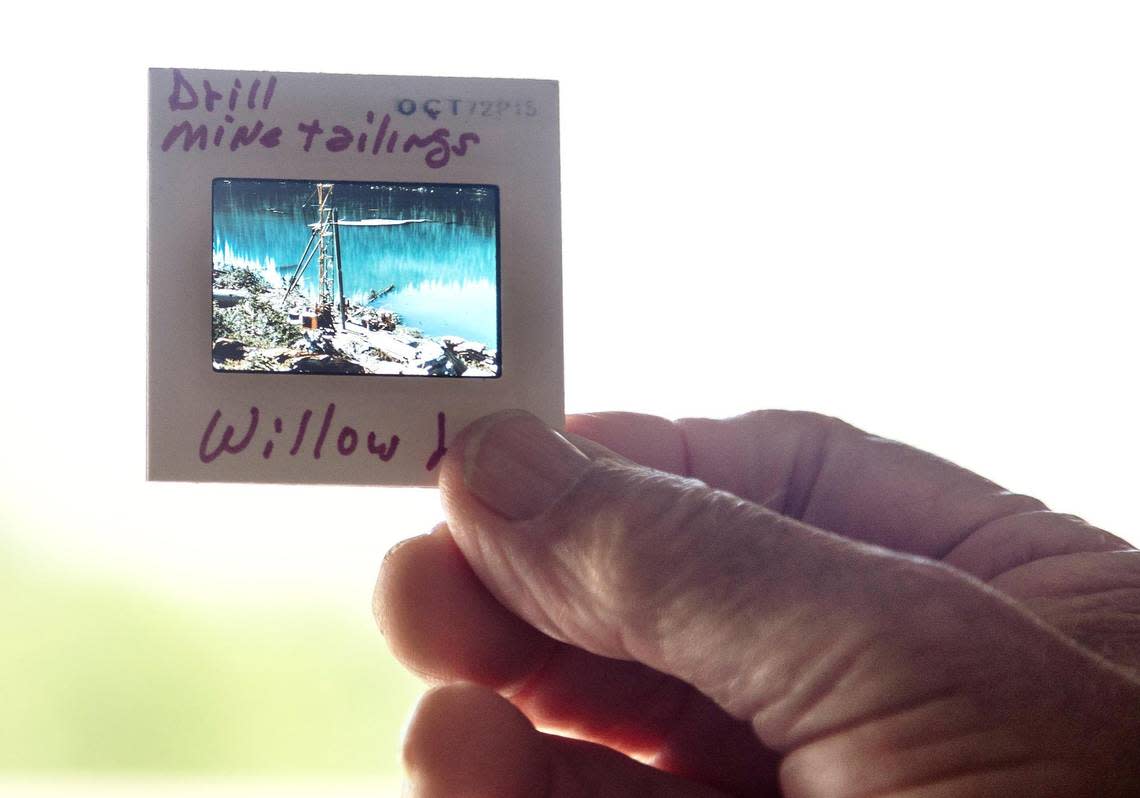 Bill Platts holds a photo slide that he made in 1972 of drill mining effluent he saw at Willow Lake while working as a biologist in the White Clouds.