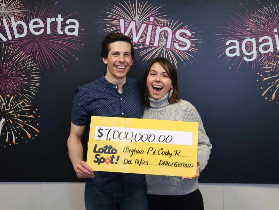 Couple holding a $7 million lottery cheque