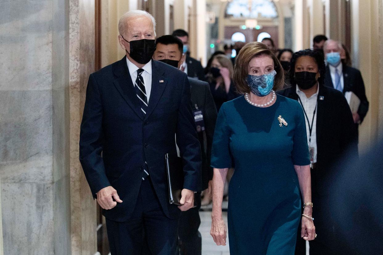 President Biden walks with Speaker of the House Nancy Pelosi on Capitol Hill in Washington, on Oct. 28, 2021, during a visit to meet with House Democrats. Biden is pushing his revised domestic policy bill and a related bipartisan infrastructure plan with fractious House Democrats after days of prolonged negotiations over his ambitious social and climate policies and how to pay for them.