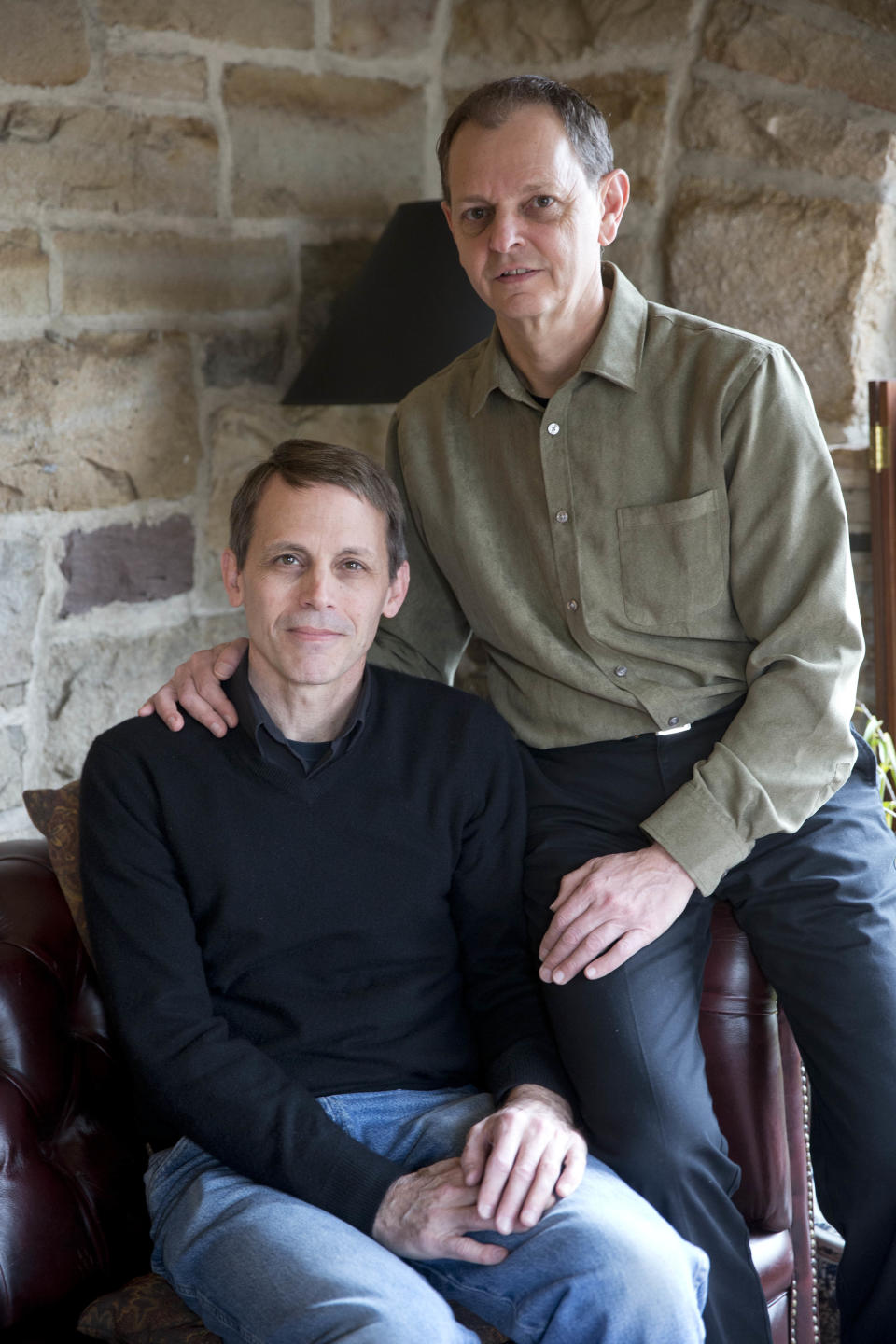 In this March 23, 2014 photo, Carl Bechdel, left, and his husband Dan Miller, pose for a photograph at their home in Harrisburg, Pa. It took two months of near daily phone calls and emails to an insurer for Bechdel and Miller to get family coverage under the federal health law. The couple was initially told their application was not processed because Pennsylvania doesn't recognize their marriage. Gay couples are finding that access to such family plans is not guaranteed, as the Obama administration seeks belatedly to ensure equitable coverage is available for same-sex spouses. (AP Photo/Matt Rourke)