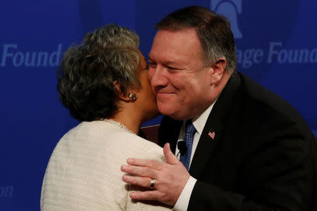 U.S. Secretary of State Mike Pompeo is greeted by Heritage Foundation President Kay Coles James with a kiss on the cheek as he arrives to deliver remarks on the Trump administration's Iran policy at the Heritage Foundation in Washington, U.S. May 21, 2018. REUTERS/Jonathan Ernst