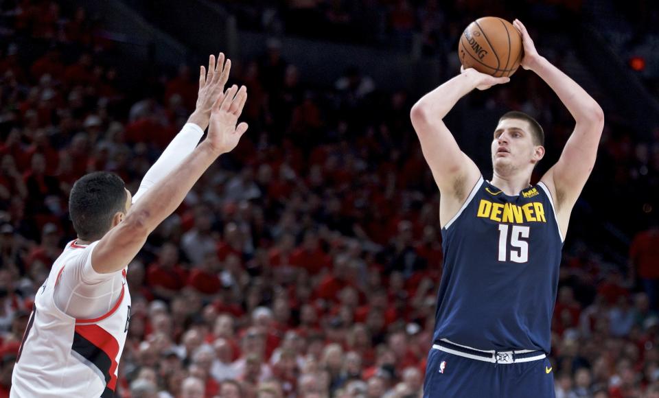 Denver Nuggets center Nikola Jokic, right, looks to shoot over Portland Trail Blazers center Enes Kanter during the first half of Game 4 of an NBA basketball second-round playoff series Sunday, May 5, 2019, in Portland, Ore. (AP Photo/Craig Mitchelldyer)