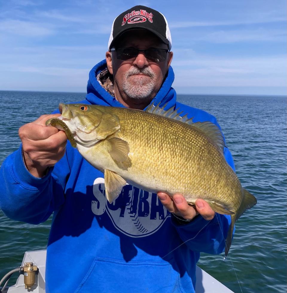 Outdoor correspondent Art Holden shows off his personal-best 19-inch, 4-pound, 10-ounce smallmouth bass that he caught May 11 on Lake Erie out of Erie, Pa. Unable to find the smallies in Presque Isle Bay, a 10-mile drive east on the lake proved to be a good choice.