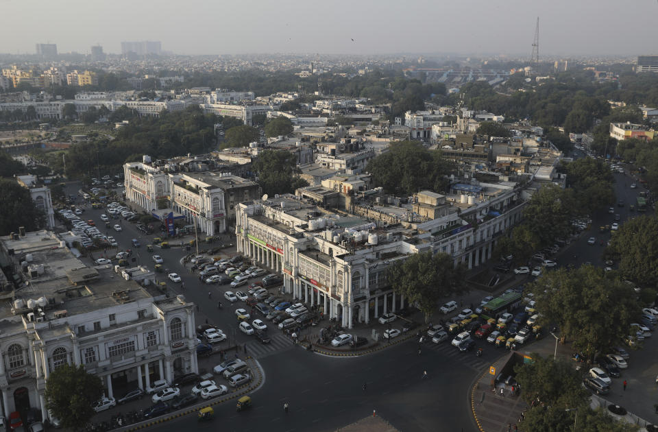 Traffic plies on a relatively clear day in New Delhi, India, Tuesday, Nov. 19, 2019. India's Parliament has discussed the toxic air threatening the lives of the capital region's 48 million people, with opposition leaders demanding the creation of a parliamentary panel to remedy the situation on a long-term basis. (AP Photo/Altaf Qadri)