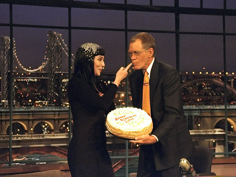 Cher feeds cake to Dave for his birthday on "The Late Show with David Letterman," April 12, 1999 on the CBS Television Network. Photo: Alan Singer/CBS ©1999 CBS Broadcasting Inc.