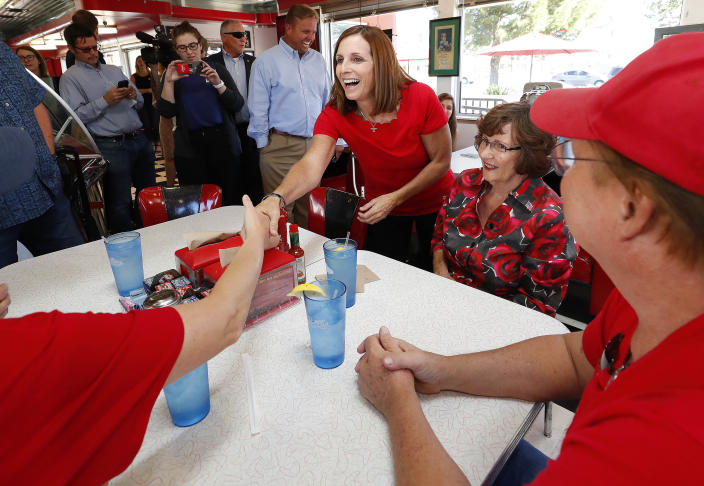 Arizona Republican senatorial candidate Martha McSally, speaks with voters, Tuesday, Nov. 6, 2018, at Chase's diner in Chandler, Ariz. McSally and Democratic challenger Kirsten Sinema are seeking the senate seat being vacated by Jeff Flake, R-Ariz., who is retiring in January. (AP Photo/Matt York)
