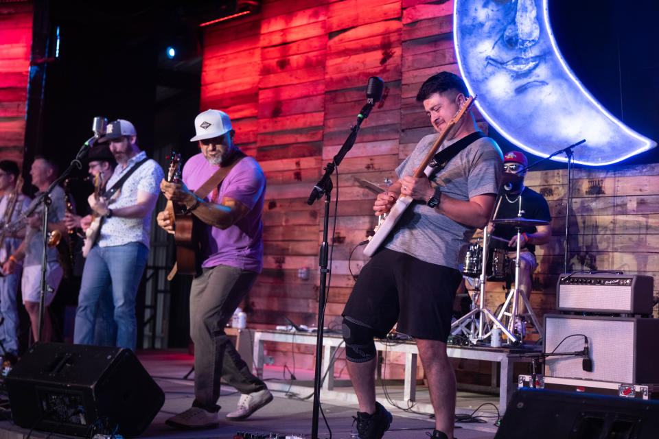 members of Velvet Funk spar on the guitar Saturday evening at the 1st annual Calf Fry Festival at the Starlight Ranch Event Center in Amarillo.