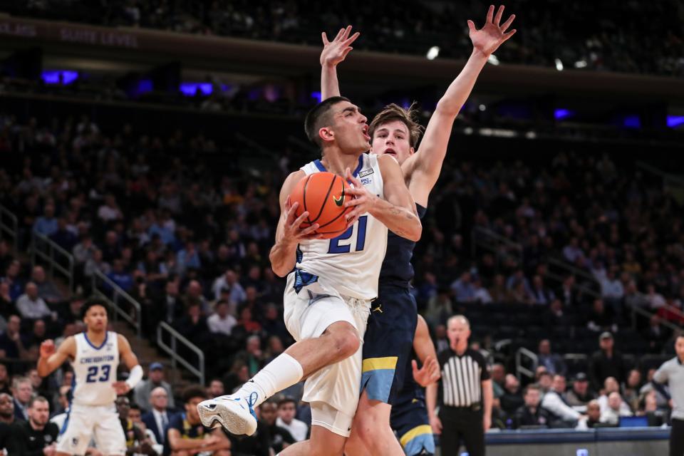Creighton guard Rati Andronikashvili drives past Marquette's Tyler Kolek in the second half at the Big East tournament at Madison Square Garden.